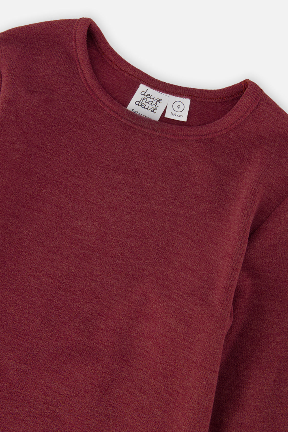 Close-up of the brushed rib knit and crew neckline in reddish-brown