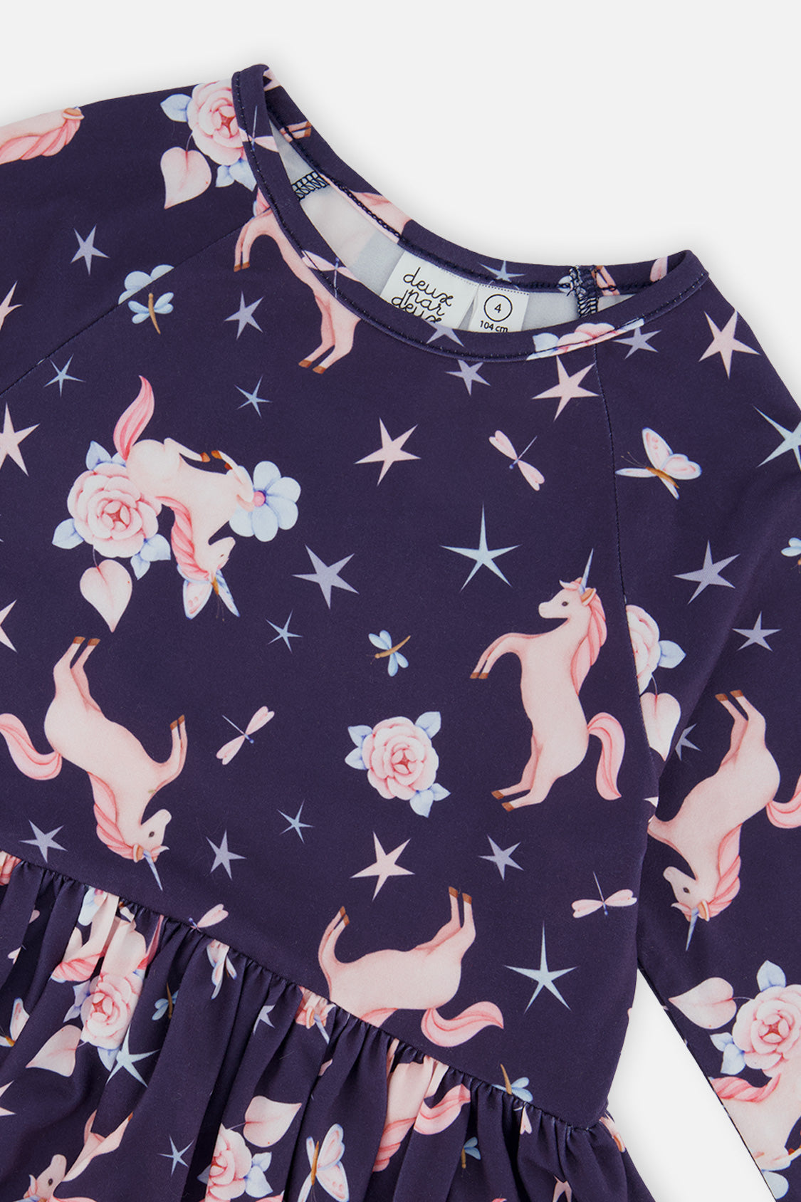 Close-up of the pink unicorns, roses and stars on the navy jersey dress