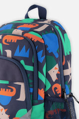 Closeup of Navy dinosaur backpack with printed compartments, side pocket, and zipper detail.