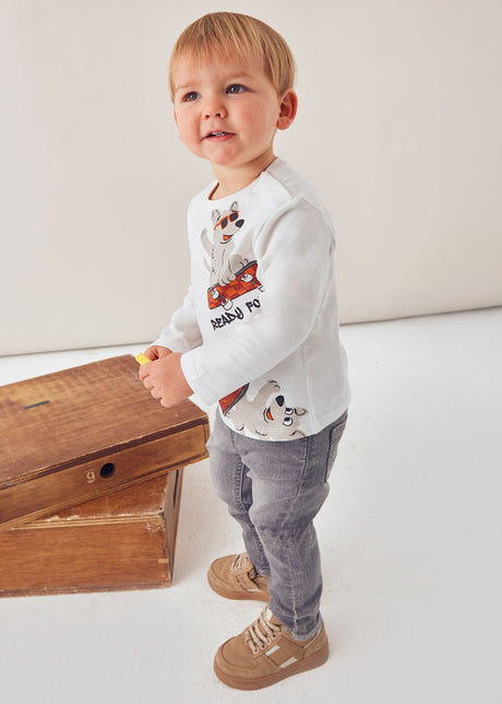 Toddler side view showing relaxed fit and soft cotton jersey.