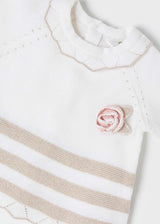 Closeup of fine-gauge knit and neck/applique detail on jumper.