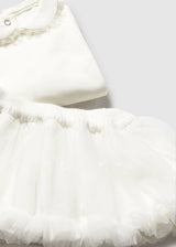 Close-up of Ivory skirt fabric with elastic waistband and soft ruffles