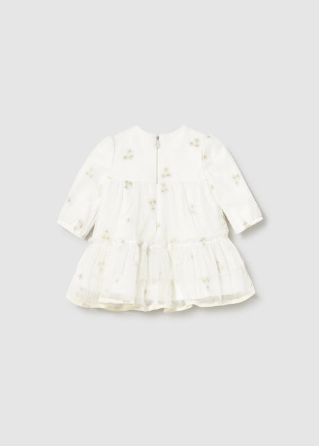 Back view highlighting the concealed zipper and ruffle tiers.