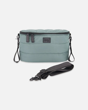 Deux par Deux sage green quilted mini diaper bag with stroller clips and a black shoulder strap