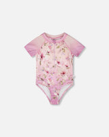 Front flat lay of Deux par Deux girl one-piece swimsuit in purple flower print