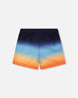 Back view of blue and orange ombré swim shorts for boys
