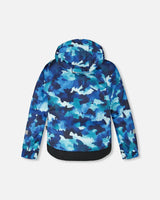 Back view of jacket and snow pants set with detachable hood and snow skirt, blue camo/orange.