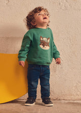 Baby boy wearing Mayoral slim fit jeans with casual top and sneakers for daycare or playdates.