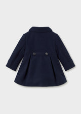 Back of the navy coat with two buttons on a waist tab and a box pleat