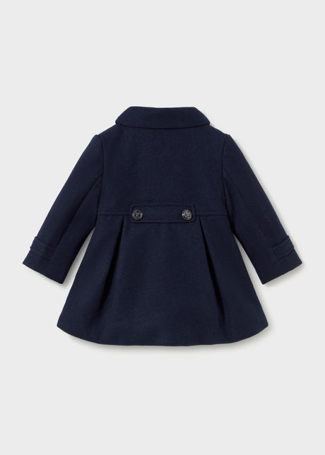 Back of the navy coat with two buttons on a waist tab and a box pleat