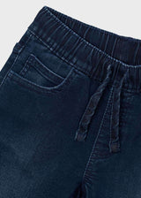 Close-up of Mayoral boys jeans showing elastic waist, drawstring-style detail, and dark denim fabric.