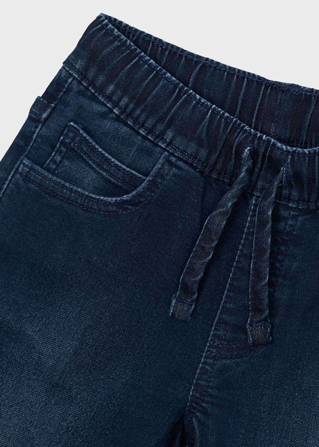 Close-up of Mayoral boys jeans showing elastic waist, drawstring-style detail, and dark denim fabric.