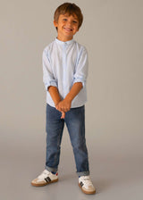 Boy standing in Mayoral Blue jeans showing regular fit and easy everyday styling.