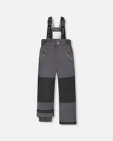 Flat lay of Deux Par Deux kids snow pants dark gray with suspenders