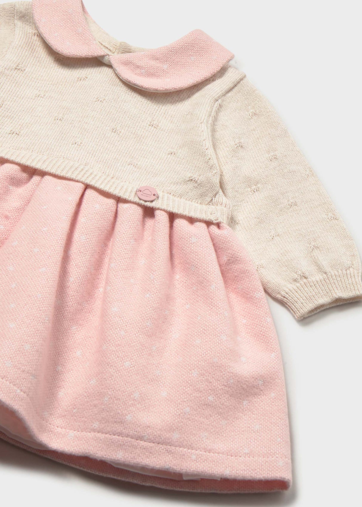 Close-up of Mayoral newborn girl knit dress showing Pink collar, Ivory knit bodice, and soft Pink skirt.